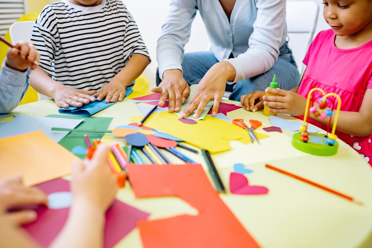 Children working together on creative activities at a colourful table
