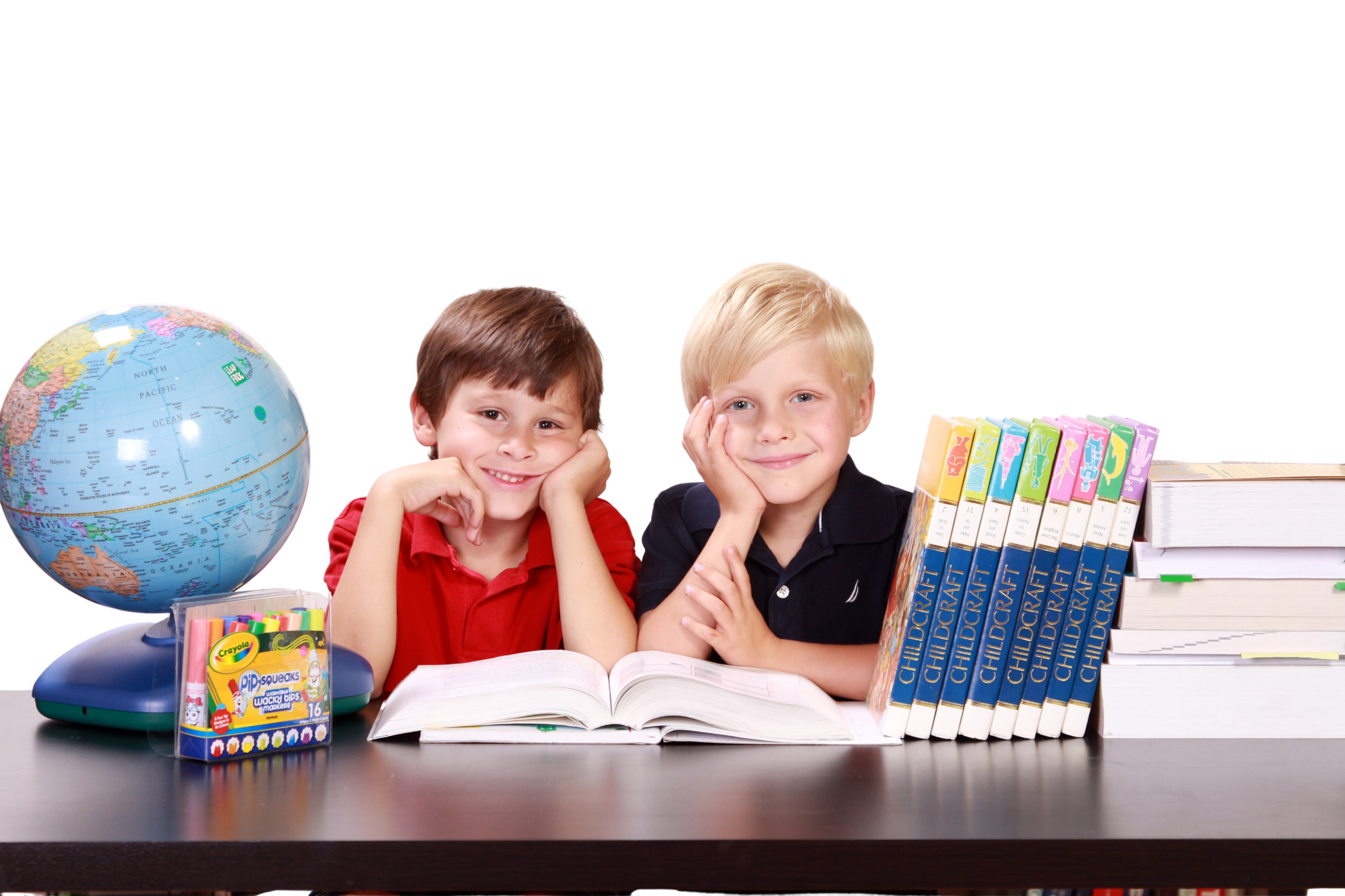 Child solving maths equations on a whiteboard in a classroom